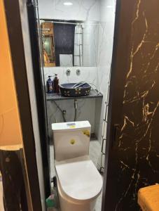 a bathroom with a white toilet and a counter at Sleep Cubee Hostel in Hong Kong