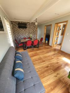 a living room with a couch and a table at Casa familiar in Cochrane