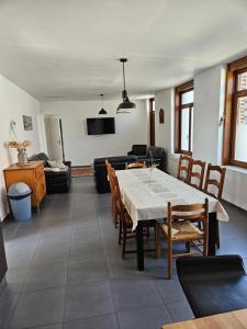 - un salon avec une table, des chaises et un canapé dans l'établissement Gite canard, à Fromelles
