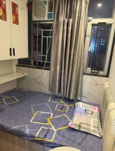 a room with a bed in a kitchen with a window at Sleep Cubee Hostel in Hong Kong