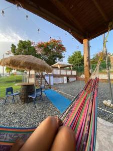 a woman laying in a hammock in a backyard at Villa Retiro R in Boquerón Area in Cabo Rojo