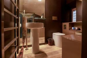 a bathroom with a sink and a toilet at CadensPlace - Overlooking Piazza Navona by dbalconycollection in Rome +29 photos