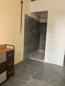 a bathroom with a shower in the corner of a room at Hostal YOA Suite 101 in Mexico City
