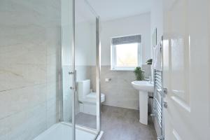 a bathroom with a shower and a toilet and a sink at Rooms at The Dressers Arms in Chorley