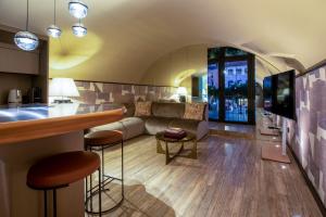 a living room with a couch and a table at CadensPlace - Overlooking Piazza Navona by dbalconycollection in Rome