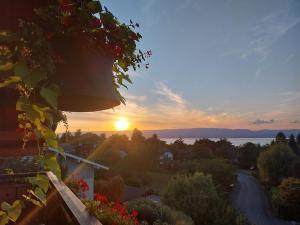a sunset from the balcony of a house at Le Chalet des 3 Ours in Neuvecelle
