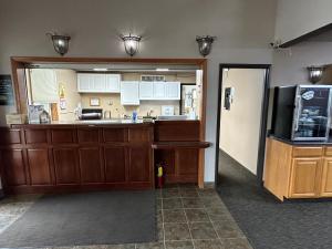 a kitchen with a sink and a refrigerator at De Smet Super Deluxe Inn & suites in De Smet