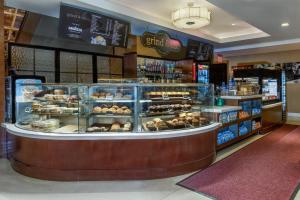 a bakery with a display case filled with pastries at Crowne Plaza Times Square Manhattan, an IHG Hotel in New York