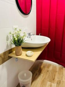 baño con lavabo y cortina de ducha roja en Infinity room, en Cerreto Alto