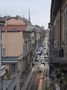 a busy city street with cars parked on the road at Calandra 15 - Torino Centro in Turin