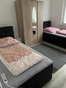 1 Schlafzimmer mit 2 Betten und einem Spiegel in der Unterkunft FeWo und Monteurzimmer Wesel in Wesel