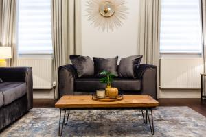 a living room with a couch and a coffee table at Stay Coastal in Whitley Bay