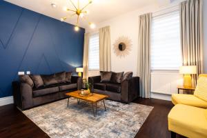 a living room with a couch and a table at Stay Coastal in Whitley Bay