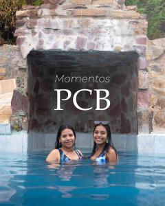 two girls are standing in the water at the mremember pcb at Punta Cocos Beach Casitas in Zorritos