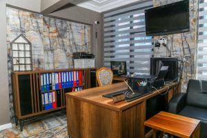 an office with a desk with a computer and a tv at Asitane Life Hotel in Istanbul