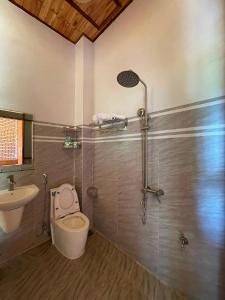 a bathroom with a toilet and a sink and a shower at Mộc House in Kon Tum Kơ Pang