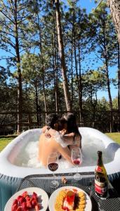 a couple kissing in a bath tub with wine glasses at Tres Lunas Domo in Mazamitla