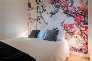 a bedroom with a bed with a floral wall at Tra gli Alberi e il Mare in Sirolo