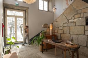 a room with a table with a laptop on it at Memoria Porto FLH Hotels in Porto