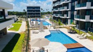 an image of a swimming pool at a resort at Makia Beach Experience # Flat Térreo B-019 in Porto De Galinhas