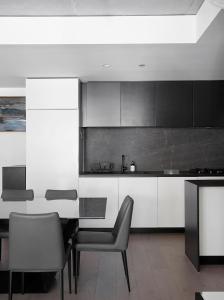 a kitchen with a table and chairs in a room at 'Modern Minimalism' Slate Chic in the City in Melbourne