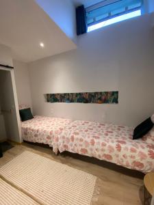 1 dormitorio con 1 cama con colcha de flores en Suite Luzilloise, en Luzillé