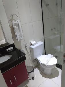 a bathroom with a toilet and a sink and a shower at Dom Quixote São Gonçalo Hotel in São Gonçalo