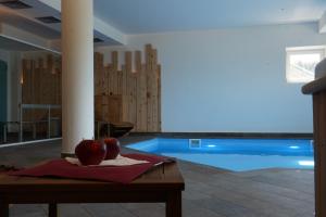 an apple sitting on a table in front of a swimming pool at Hotel Residence Bellavista - Camping Polsa in Brentonico +40 photos