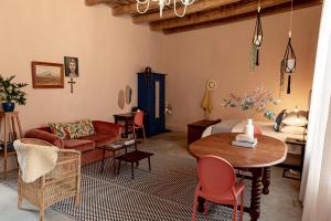 a living room with a couch and a table at Hartland Huis in Graaff-Reinet