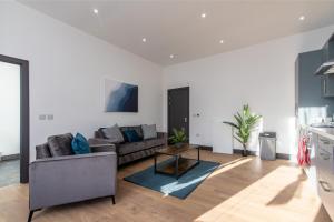 a living room with a couch and a table at Victoria Apartments: Contractor's Choice 3BR in Hartlepool in Hartlepool