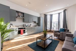a kitchen and living room with a couch and a table at Victoria Apartments: Contractor's Choice 3BR in Hartlepool in Hartlepool