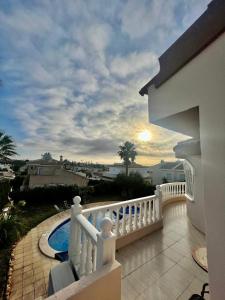 a balcony of a house with a swimming pool at Villa Calma in Ciudad Quesada
