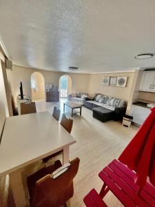 a living room with a table and a couch at Villa Calma in Ciudad Quesada