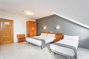 Łóżko lub łóżka w pokoju w obiekcie Hotel Alda Ciudad de Toro