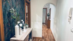 a hallway with a table with vases on it at Ponte Dena in Pontevedra