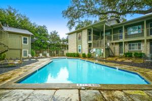 a swimming pool in front of a house at Creekside Terrace Condominiums #211 in Austin