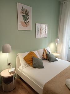 a bedroom with a large white bed with pillows at 111 Guest House in Rome