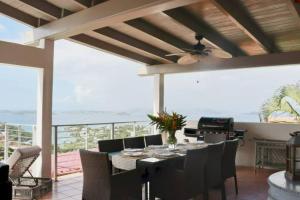 a dining room with a table and chairs at Mandavilla - Inspired USVI- Generator - Starlink in Cruz Bay