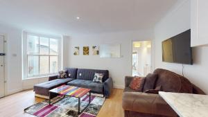 a living room with a couch and a table at My Lovely Clapham Flat in London