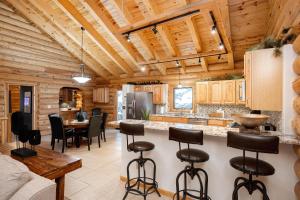 a kitchen and living room in a log cabin at Iconic Log Cabin Escape - Idaho Springs - Hot Tub in Idaho Springs