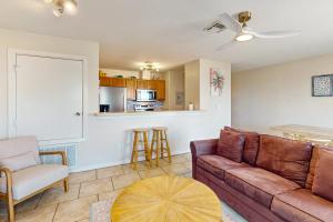 a living room with a couch and a kitchen at Leeward 9303 in Padre Island