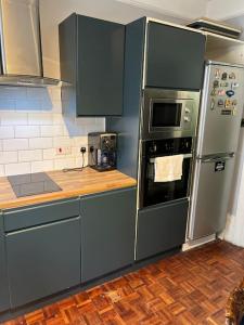 a kitchen with stainless steel appliances and a wooden floor at Central London Apartment (1) in London