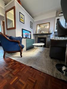 a living room with a couch and a fireplace at Central London Apartment (1) in London