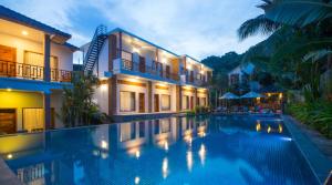 a swimming pool in front of a house at Nadine Phu Quoc Resort & Spa in Phu Quoc