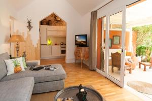 a living room with a couch and a table at Bungalow Melocotones Maspalomas Golf in Maspalomas