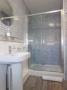 a bathroom with a shower and a sink and a tub at Tywyn Beach House in Tywyn +34 photos