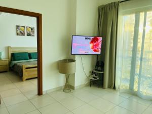 a room with a flat screen tv on the wall at Amazing 1 bedroom apt in Marina in Dubai
