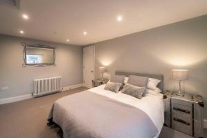 a bedroom with a large bed and a mirror at 3 The Steyne - Stunning 5 Storey Georgian house with cinema room in Worthing