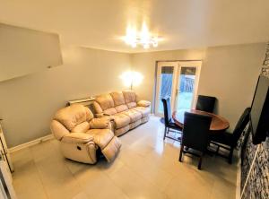 a living room with a couch and a table at High Rigg House Bradford - Luxury Accomodation with Private Parking in Idle