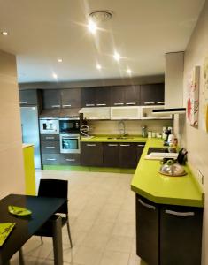 cocina con encimera verde y mesa en Casa Pablo Picasso 9, en Jimena de la Frontera